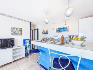 a kitchen with a breakfast bar with blue accents at Holiday Home TY Greg by Interhome in Crozon