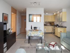a living room and kitchen with a table and a couch at Apartment Bella Vista Apt- No- 09 by Interhome in Wengen +24 photos