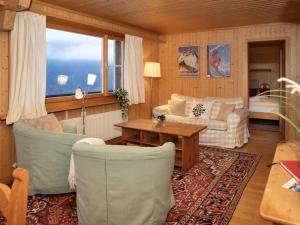 a living room with a couch and chairs and a table at Apartment Plein Soleil by Interhome in Wengen