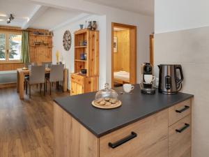 a kitchen with a counter with a coffee maker on it at Apartment Baroudeur B04 by Interhome in Verbier