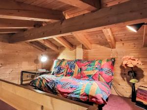 a bedroom with a couch in a room with wooden walls at Apartment Chalet mit Bergsicht by Interhome in Laax +26 photos