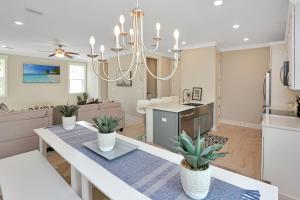 a kitchen and living room with a chandelier at Just Beach Baby! by Pristine Property Vacation Rentals in Cape San Blas