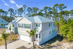 an exterior view of a house with palm trees at Just Beach Baby! by Pristine Property Vacation Rentals in Cape San Blas