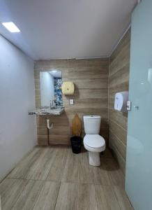 a bathroom with a toilet and a mirror at Pousada e Hostel Natal in Natal +25 photos