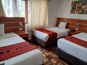 a hotel room with two beds and a window at Dannas Inn in San Antonio