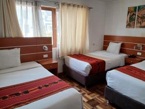 a hotel room with two beds and a window at Dannas Inn in San Antonio