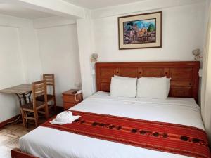 a bedroom with a bed and a table and a chair at Dannas Inn in San Antonio