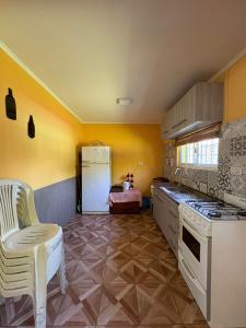 a kitchen with a stove and a white refrigerator at El Colibrí 1 in Arroyo Seco