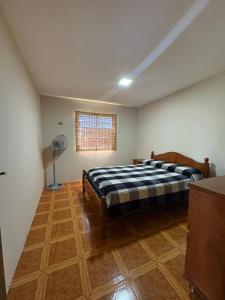 a bedroom with a bed and a window and a fan at El Colibrí 1 in Arroyo Seco +8 photos
