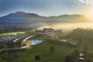 an aerial view of a resort in the mountains with fog at Pension Speckmoser in Bad Mitterndorf