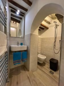 a bathroom with a sink and a toilet and a shower at Tolletta 10 e Lode in Arezzo