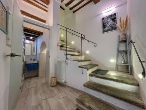 a staircase in a home with white walls and wooden floors at Tolletta 10 e Lode in Arezzo