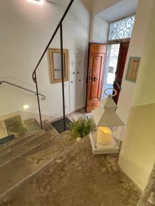 a room with stairs with a lamp and a door at Tolletta 10 e Lode in Arezzo +35 photos