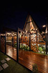 a wooden deck at night with lights on it at Cabana Escandinávia Praia de Fora in Palhoça