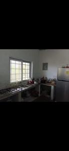 a large kitchen with a sink and a window at Boca de viento Chica in Chicá +2 photos