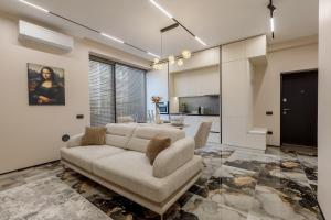 a living room with a couch and a table at Renest Florence Art Escape in Chişinău