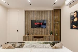 a living room with a tv on a wooden wall at Renest Florence Art Escape in Chişinău +23 photos