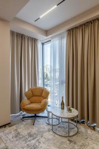 a living room with a chair and a table at Renest Florence Art Escape in Chişinău