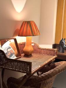 a lamp sitting on top of a table with a mirror at Rodoserv Hotel in Pardinho