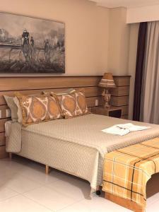 a bedroom with a bed and a painting on the wall at Rodoserv Hotel in Pardinho