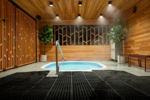 a jacuzzi tub in a room with wooden walls at Gravity Haus Revelstoke in Revelstoke