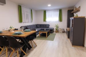 a living room with a table and a couch at Apartman Kelečić in Gornji Stupnik +11 photos