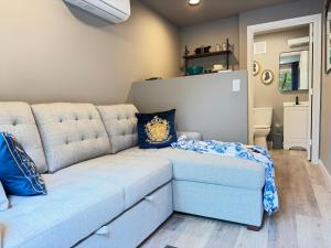 a living room with a blue couch in a room at Romantic Riverfront Retreat in Sugar Run