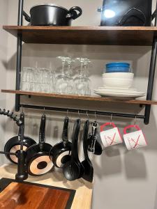 a kitchen rack with utensils on a shelf at Romantic Riverfront Retreat in Sugar Run