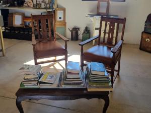 two chairs and a table with books on it at Betta Lodge in Duwisib