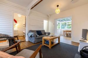 a living room with a couch and a table at Ty Capel Bach in Bodorgan