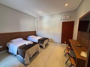 Hotel Tibério Filho tesisinde bir odada yatak veya yataklar