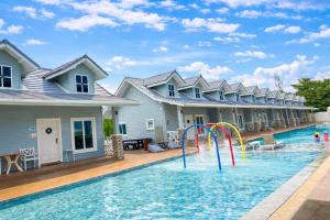 a pool with water slides in a house at Wangpruksa Resort in Ban Nong Bua