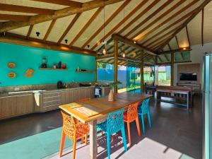 a kitchen with a large wooden table and chairs at Brisas de Bonito: ótima casa, condomínio, 2 suítes in Bonito