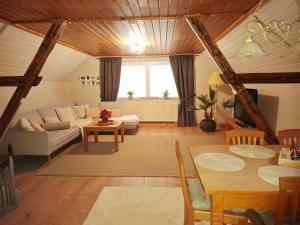 a living room with a couch and a table at Ferienwohnung "Zum Schlossblick" in Mansfeld
