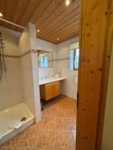 a bathroom with a tub and a sink at Pension Schweizerhaus Garni in Weyarn +71 photos