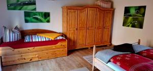 a bedroom with a wooden bed and a wooden dresser at Ferienwohnung "Zum Schlossblick" in Mansfeld +13 photos