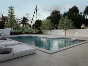 a swimming pool in the middle of a yard at Inoe Boutique Hotel in Kamari