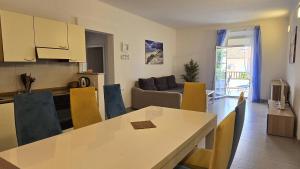 a kitchen and living room with a table and a couch at CENTRO POOL House in Novalja