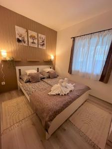 a bedroom with a bed with a dress on it at Majoros Garden Apartman in Siófok