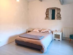 a small bedroom with a bed and a window at Maison ardéchoise atypique in Chomérac