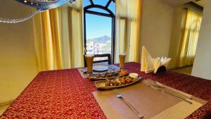 a table with a plate of food on a red table at Hotel Nomadic in Udaipur