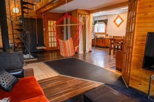 a living room with a couch and a hammock at Maison Conteneur d'Expedition in Amos