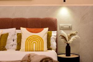 a bed with a pillow with a rainbow on it at Falco Deluxe Home - Naples Airport & Town in Naples