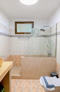 a bathroom with a tub and a sink at Oleander Garden in Alexandroupoli +25 photos