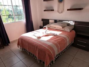 a bedroom with a bed with a red and white blanket at Casa Atardecer - Privada Los Olivos in Playa del Carmen +33 photos