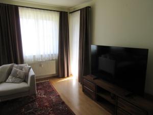 a living room with a large flat screen tv at Ferienwohnung Alpenvilla in Bischofswiesen