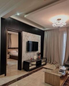 a living room with a television on a wall at Park Street Apartment in Trofwi