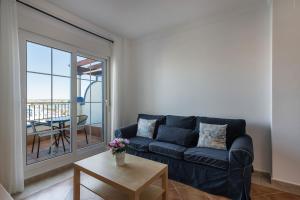 a living room with a couch and a table at Marina IV by Ĥ - Marina Isla Canela PMHIV25P25 in Isla del Moral