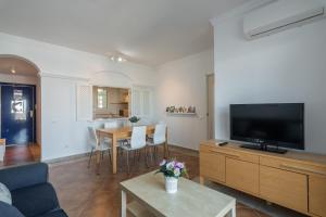 a living room with a couch and a tv at Marina IV by Ĥ - Marina Isla Canela PMHIV25P25 in Isla del Moral
