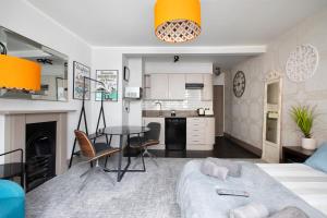 a living room with a bed and a table and a kitchen at CITY HEART BRIGHTON in Brighton & Hove +10 photos